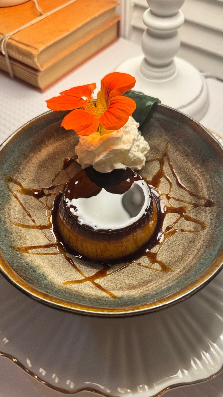 Chocolate fondant with cream and a nasturtium flower