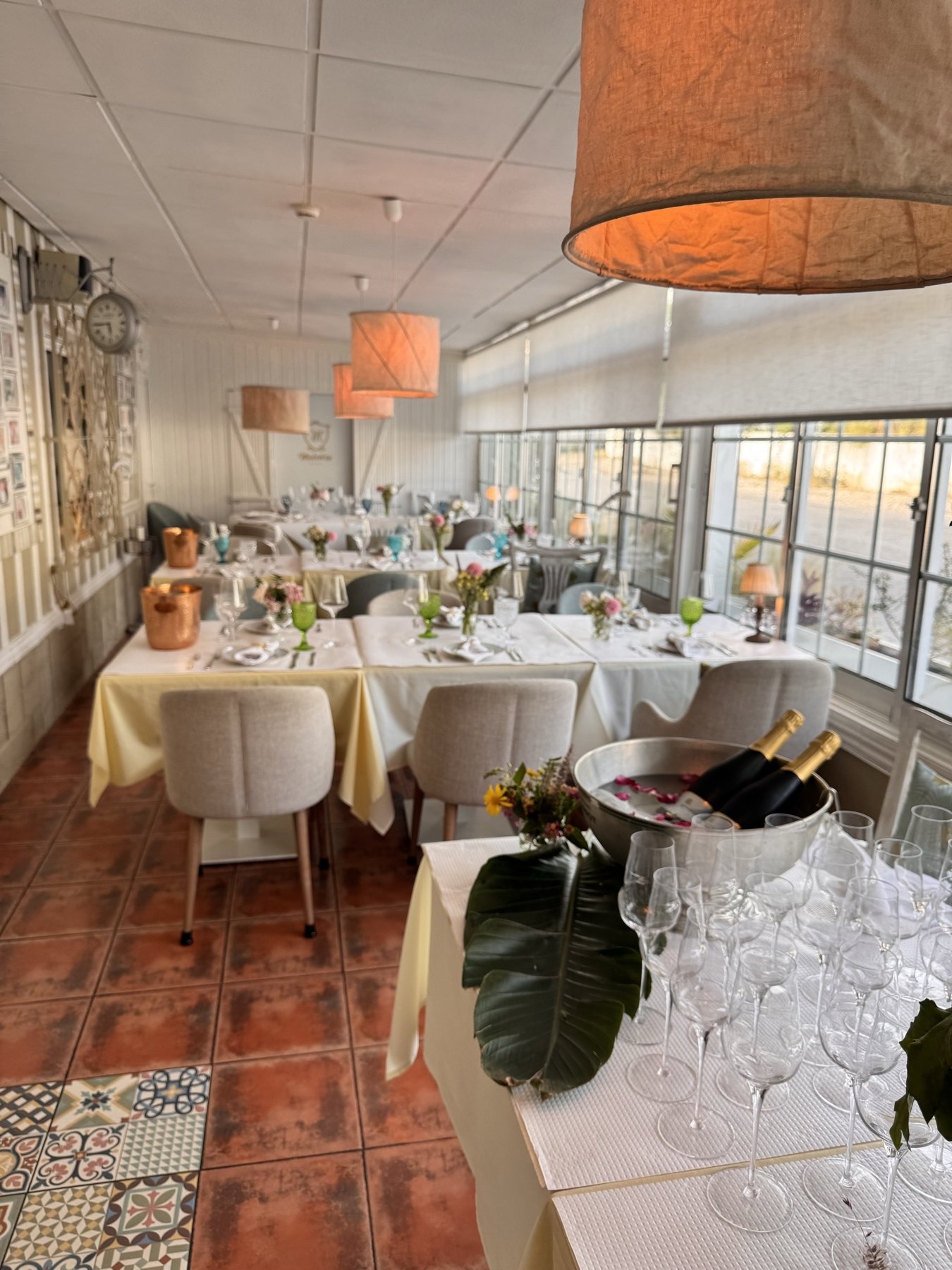 The bright dining room set for service