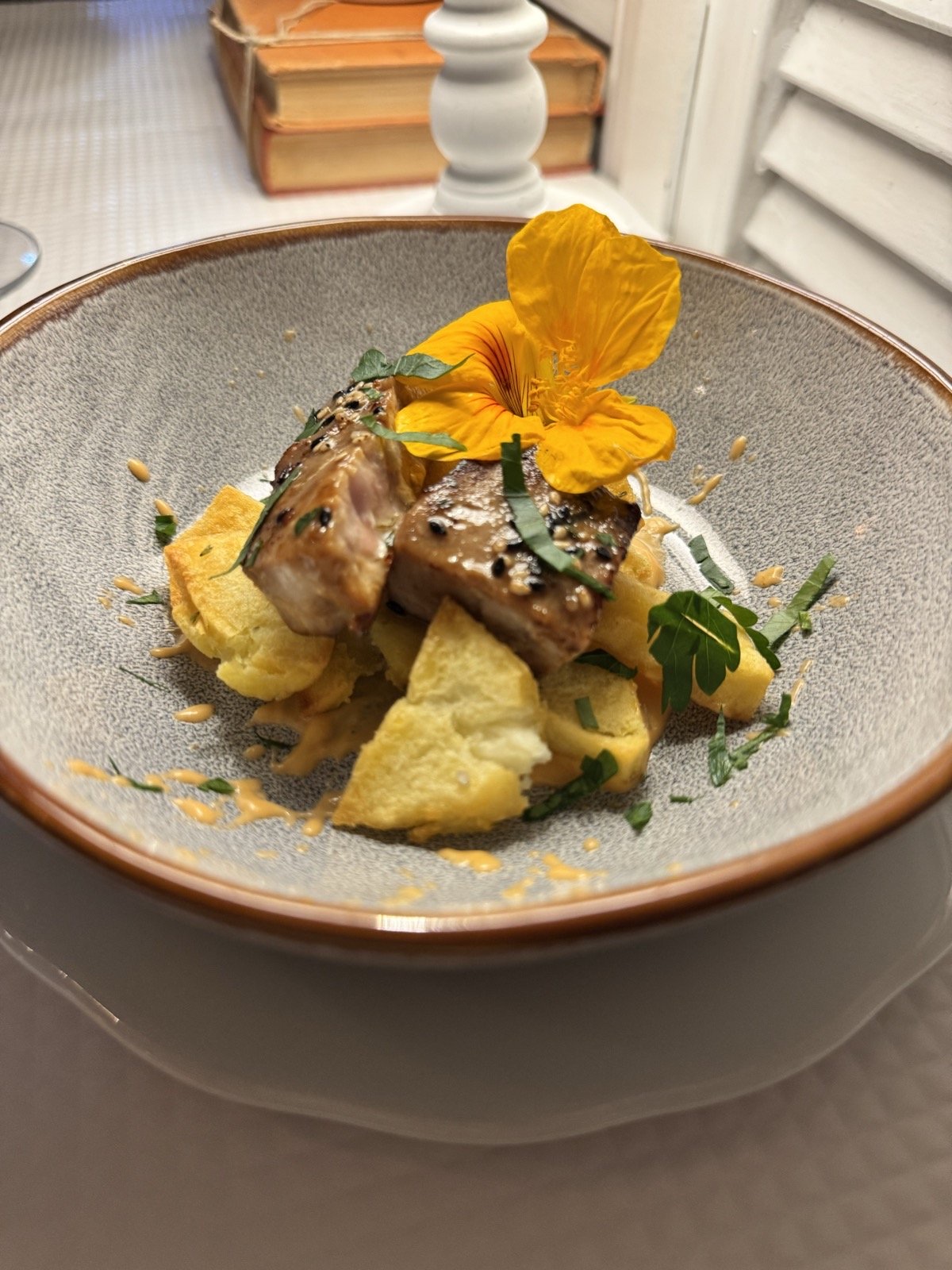 A styled plate with edible flowers at Malveiro