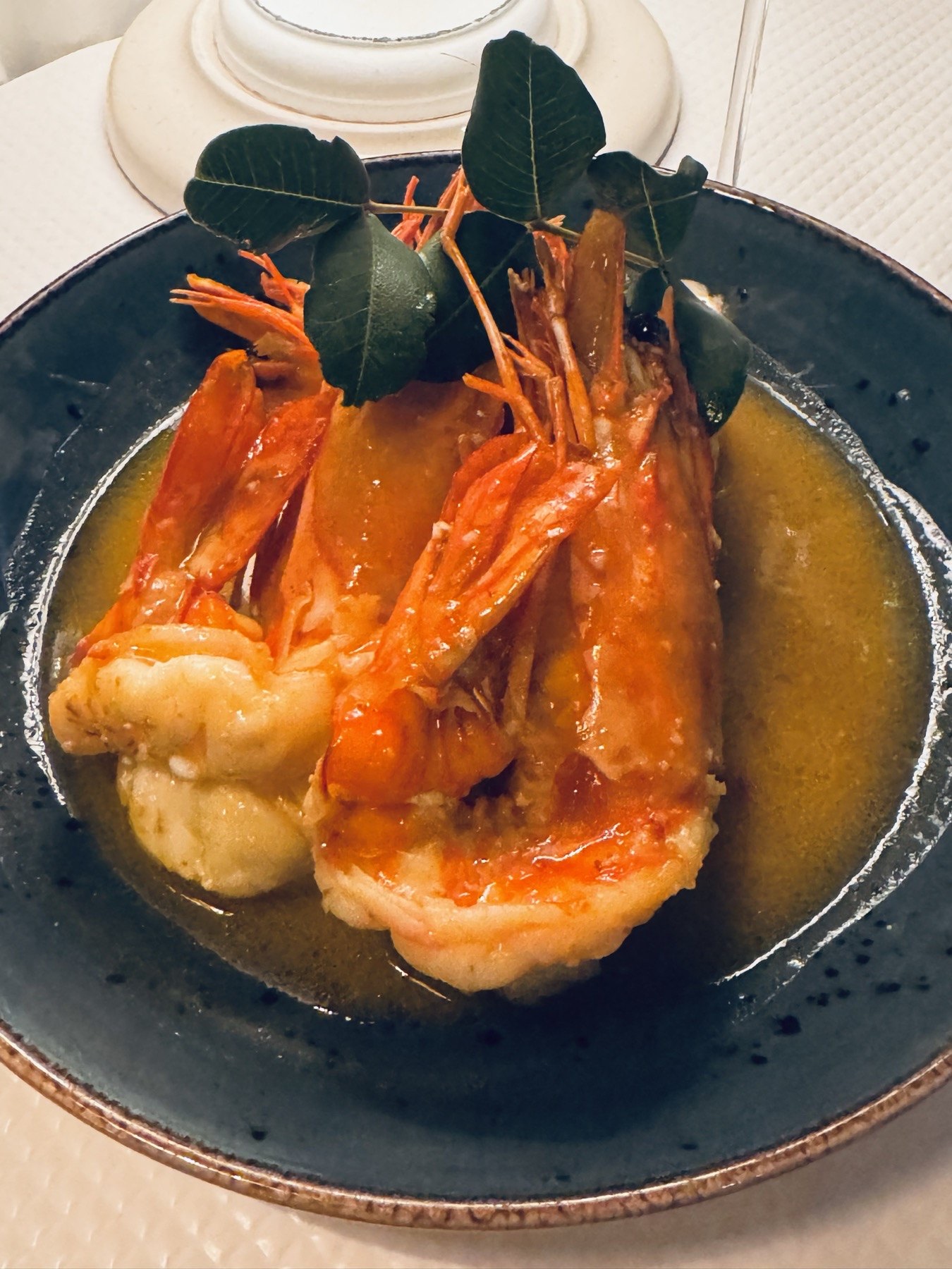 Whole red prawns in a rich broth